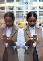 Image of a woman looking at her phone. 