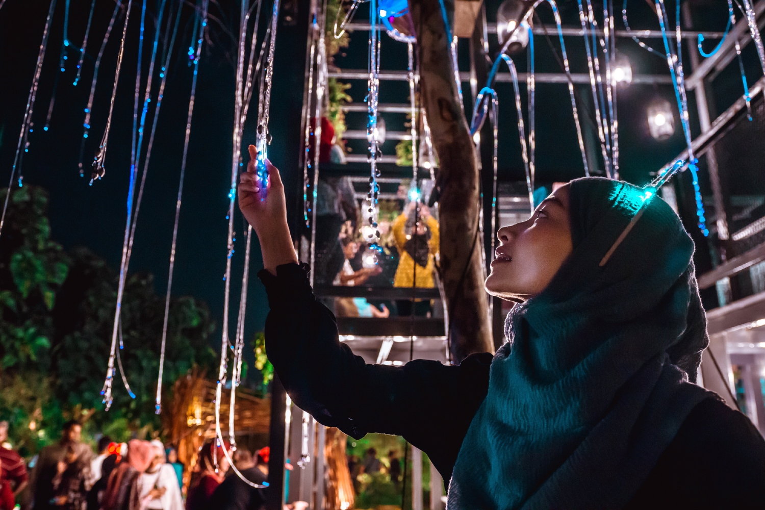 Person examining hanging fairy lights Person examining hanging fairy lights