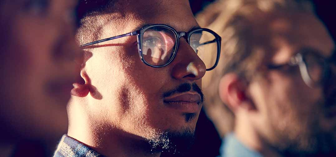 man with glasses watching a video