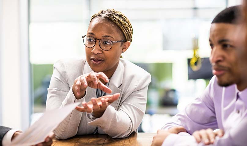 business person gesticulating during a meeting