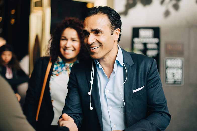 business person smiling shaking hands