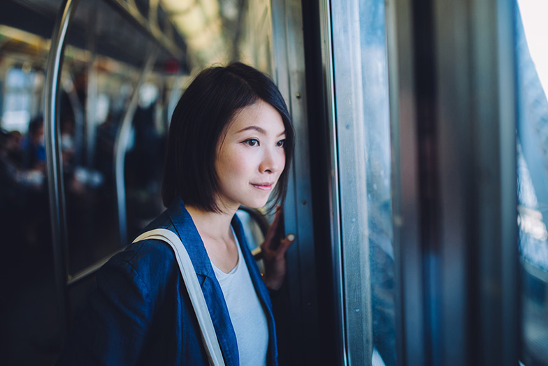 Young woman staring out window