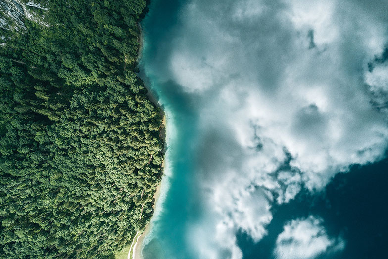 Aerial shot of land, sea and clouds