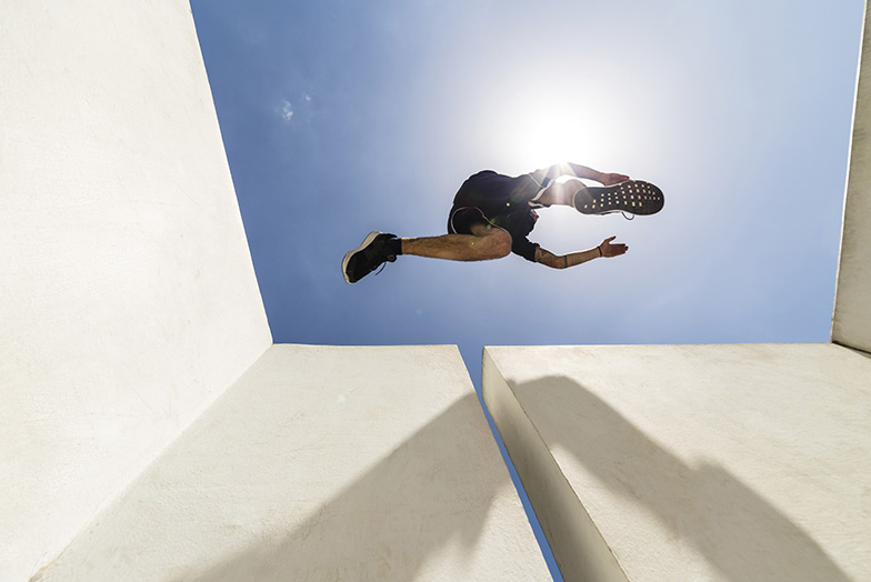 Person jumping across a gap