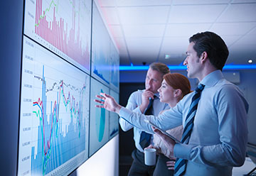 business people pointing at graphs